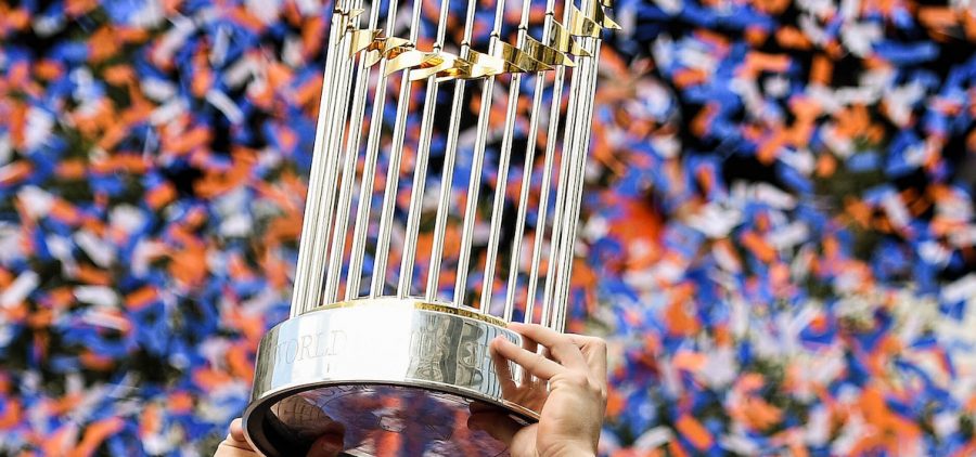hands holding up the world series trophy for major league baseball