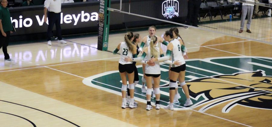 Ohio volleyball meets at the middle of the court during its match against UTEP.