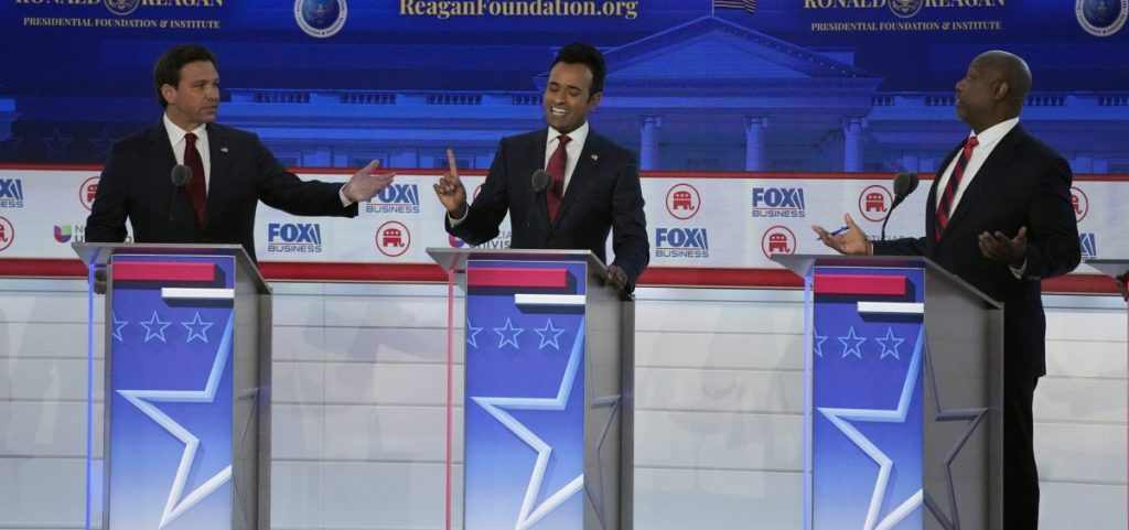 From left to right, Florida Gov. Ron DeSantis, businessman Vivek Ramaswamy and Sen. Tim Scott, R-S.C., argue a point during a Republican presidential primary debate