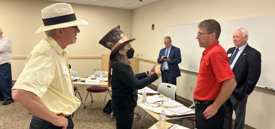 Environmental activist Roxanne Groff of Save Ohio Parks talks to Oil and Gas Land Management Commissioner Matthew Warnock, an appointee representing the oil and gas industry, following the meeting on Sept. 18, 2023.