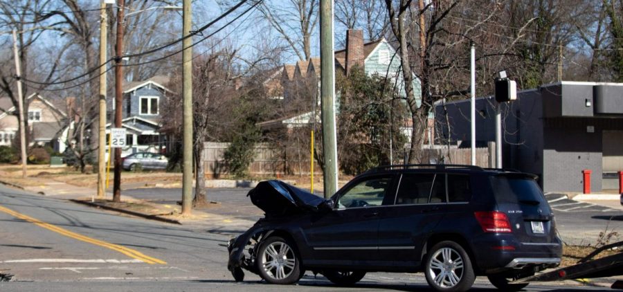 A car accident is cleared at an intersection without power in Charlotte, N.C.