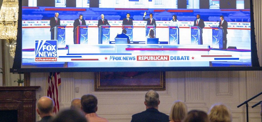 A crowd watches the first GOP Primary debate on a projection screen.
