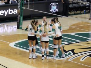 Ohio meets at the middle of the court during its match against UTEP