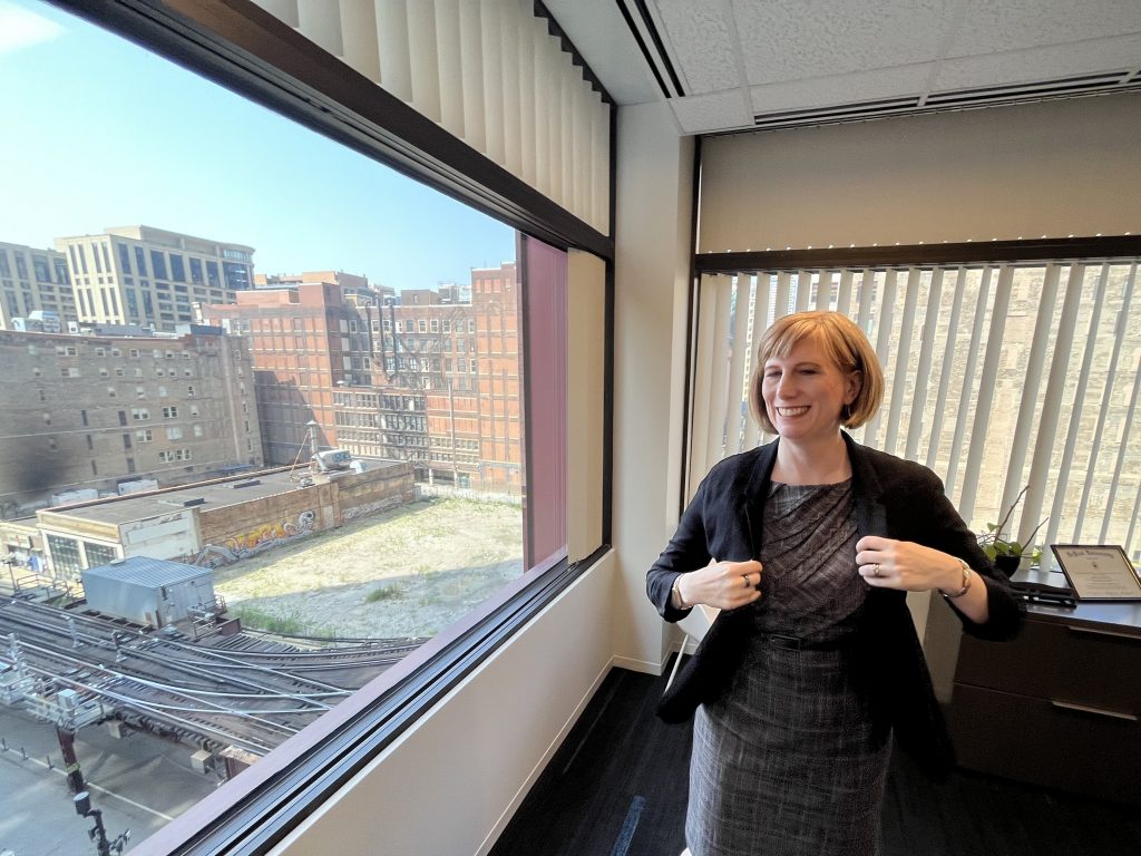 Chicago Housing Authority Inspector General Kathryn Richards puts on a blazer in her corner office that looks over some construction in the city.