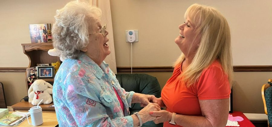 Sharon Hudson (left) has advanced Alzheimer's. But she smiles, giggles and holds hands with her daughter, Lana Obermeyer, when she visits at the Good Samaritan Society nursing home