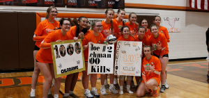 High school girls' volleyball: Nelsonville-York posses for a photo with Chloe Lehman posters celebrating her 1,000 kill