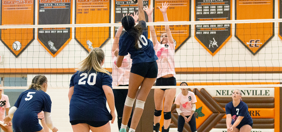 Girls Volleyball: Nelsonville-York's Gianna Dixon goes up for a kill with two Trimble Tomcats hoping to block