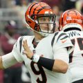 Cincinnati Bengals quarterback Joe Burrow (9) throws the ball while a lineman protects his backside.