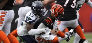 Joe Burrow is sacked by a Seattle defender during and NFL game.