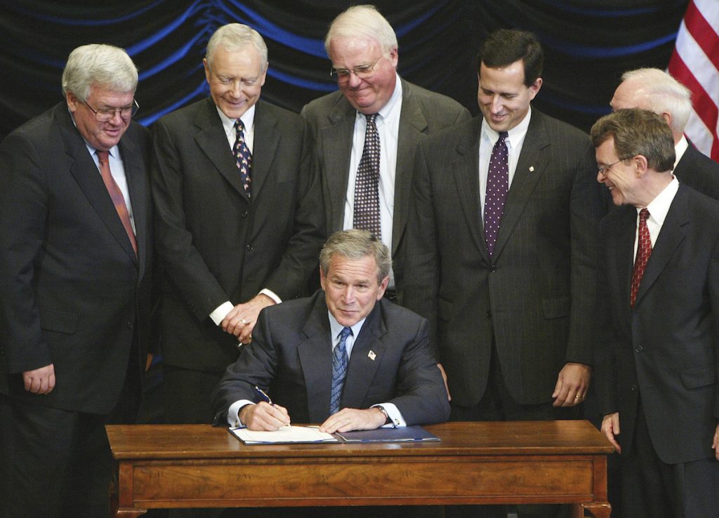 President George W. Bush signs legislation banning so-called partial-birth abortions, Nov. 5, 2003, in Washington, as from left, House Speaker Dennis Hastert of Ill., Sen. Orrin Hatch, R-Utah, Rep. James Sensenbrenner, R-Wis., Sen. Rick Santorum, R-Pa., Rep. James Oberstar, D-Minn., obscured, and Sen. Mike DeWine, R-Ohio, watch. 