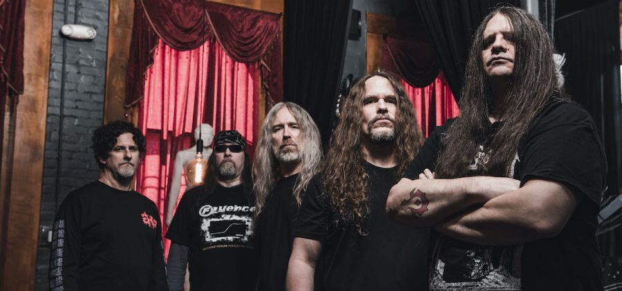 A promotional image of the band Cannibal Corpse. There are five members and they are all wearing black.
