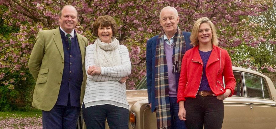 poet Pam Ayres and actor Geoffrey Whitehead with top antiquers in front of classic British car