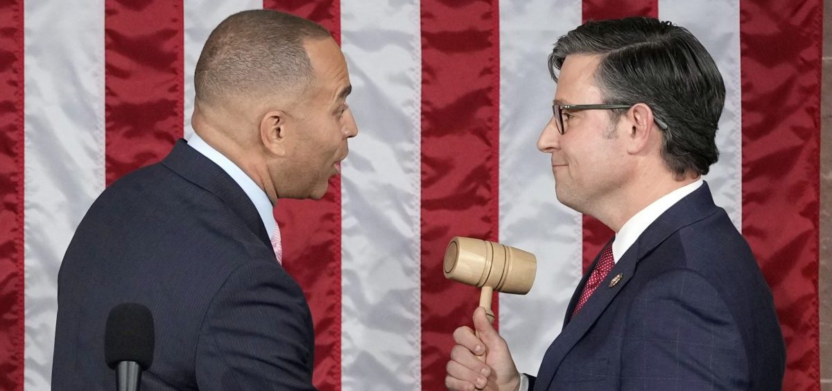 House Minority Leader Hakeem Jeffries of N.Y., hands the gavel to newly elected House Speaker Mike Johnson of Louisiana at the Capitol on Wednesday.