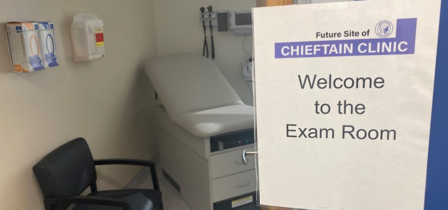 A door opens into a medical examination room. A sign on the wall reads "Welcome to the Exam Room."