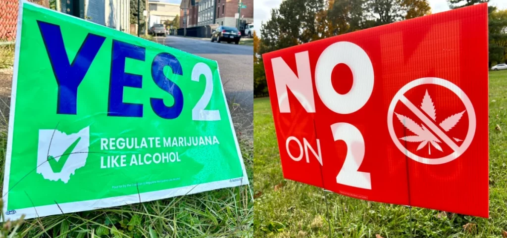 A green sign on the left supports Issue 1 and a red sign on the right opposes issue 2