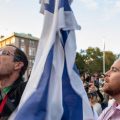 A man holds up an Israeli flag as Columbia University students participate in a rally in support of Palestine at the university on October 12 in New York City.
