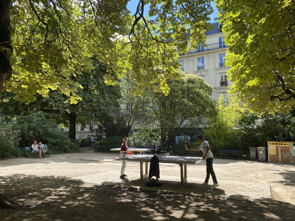 People play table tennis in a neighborhood park in Paris.