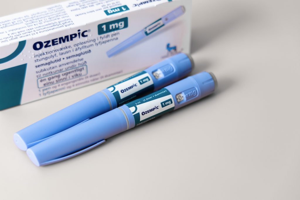 Two Ozempic Insulin injection pens next to an Ozempic box. 