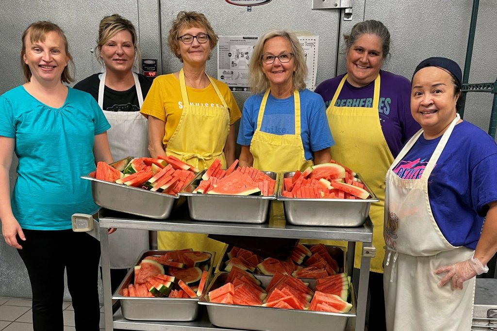 Cafeteria workers Heather Frederick, Michelle Blunt, Wendy Wheeler, Theresa Ward, Lisa Natomeli, La Quang serving up fresh watermelon.