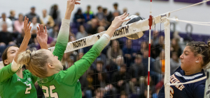 Girls High School Volleyball: Two Waterford players are up blocking a kill in front of the net from a Shenikah Christian player