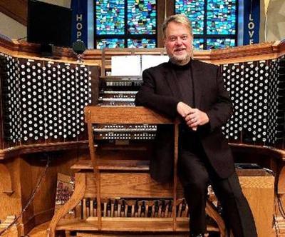An image of Rodney Barbour in front of his organ.