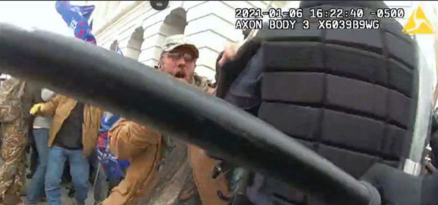 This image from video from a police worn body camera from the Jan. 6, 2021, riot at the U.S. Capitol, released by the Justice Department in the statement of facts supporting the arrest of Kenneth Joseph Owen Thomas, shows Thomas attacking law enforcement during the Jan. 6 riot