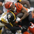 Cincinnati Bengals running back Joe Mixon, right, is tackled by Pittsburgh Steelers safety Trenton Thompson