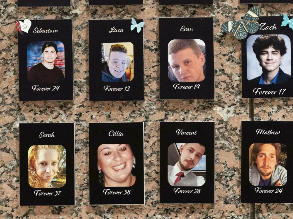 Photographs of people who had died from drugs are on display during the Second Annual Family Summit on Fentanyl at DEA Headquarters in Washington