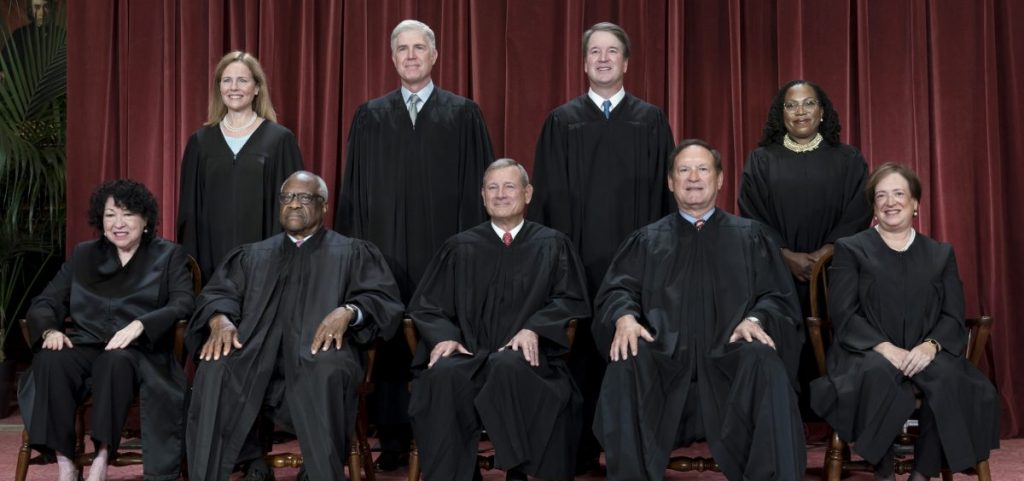 Members of the Supreme Court sit for a new group portrait following the addition of Associate Justice Ketanji Brown Jackson, at the Supreme Court building in Washington