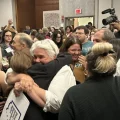 Supporters of Issue 1, the constitutional amendment to enshrine abortion and reproductive rights into Ohio's constitution, hug as the race is called for the "yes" side.