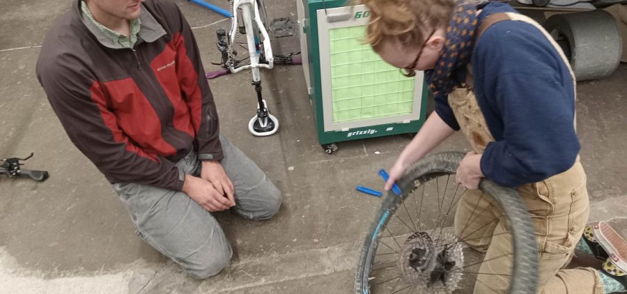 An image of people repairing a bike.