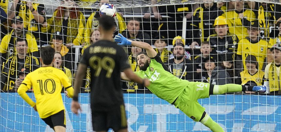 Los Angeles FC goaltender Maxime Crepeau (16) blocks a shot in front of Columbus Crew forward Diego Rossi (10) and LA Galaxy's Denis Bouanga, center, in the first half MLS soccer championship match