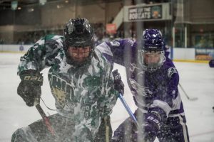 Ohio forward Luc Reeve (8) battles for the puck in Ohio's game against Niagara.
