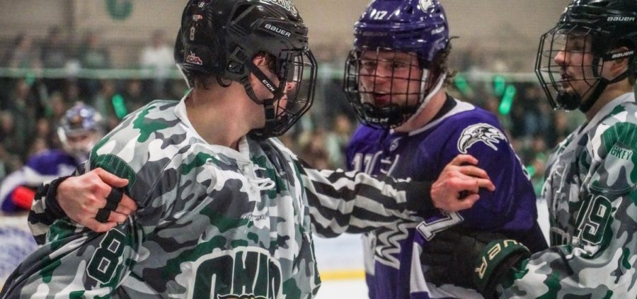 Ohio forward Luc Reeve (8) goes against a Niagara defender in Ohio's game against the Purple Eagles