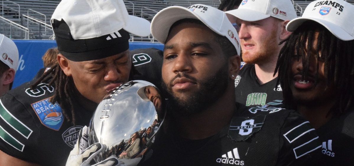 Ohio linebacker Bryce Houston (32) holds the trophy for the Myrtle Beach Bowl.