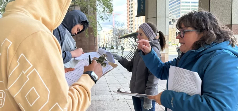 Elizabeth Grieser (center) and Amber Decker (right) gather signatures for Citizens Not Politicians near the Riffe Center in downtown Columbus.