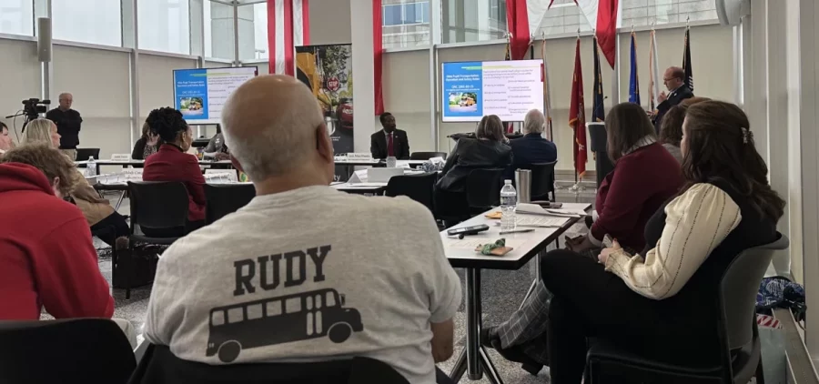 Rudy Breglia, founder of the School Bus Safety Alliance, sits at the front of a meeting of the statewide task force assessing school bus safety