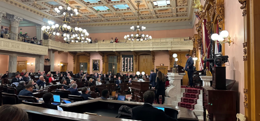 Representatives sit in the chamber of the Ohio House of Representatives. The speaker is at the podium.