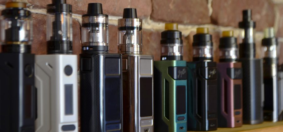 A row of vape devices on display at a store.