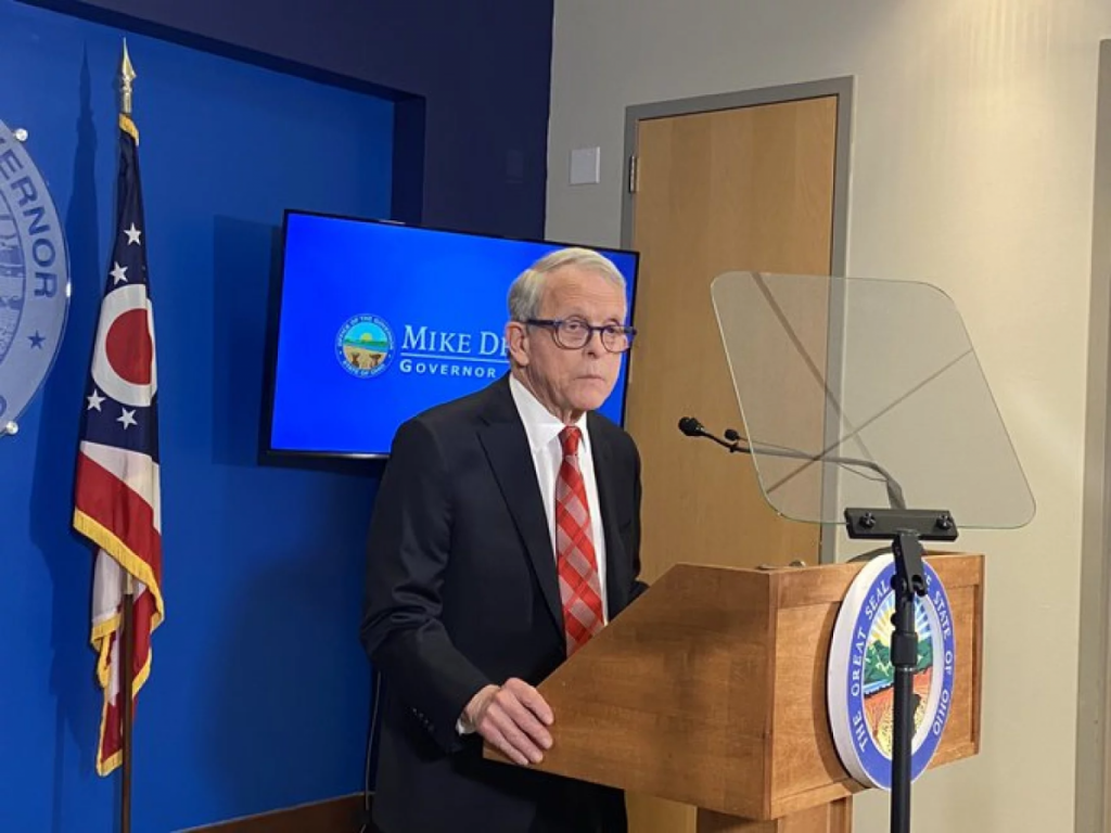 Ohio governor Mike DeWine stands at a podium.