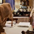 ALL CREATURES GREAT AND SMALL vet inside home with goat eating food on dining room table