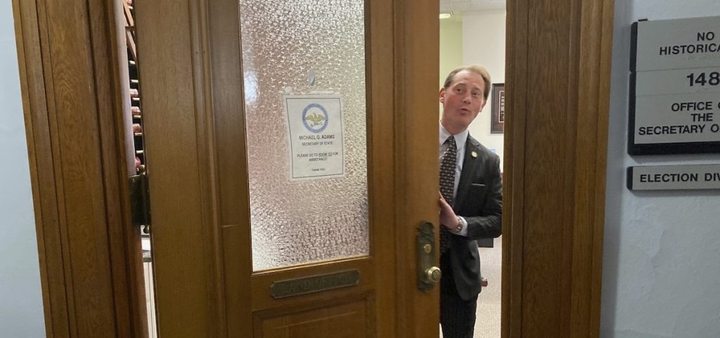 Kentucky Secretary of State Michael Adams ceremoniously closes the door to the room where candidates can file for office
