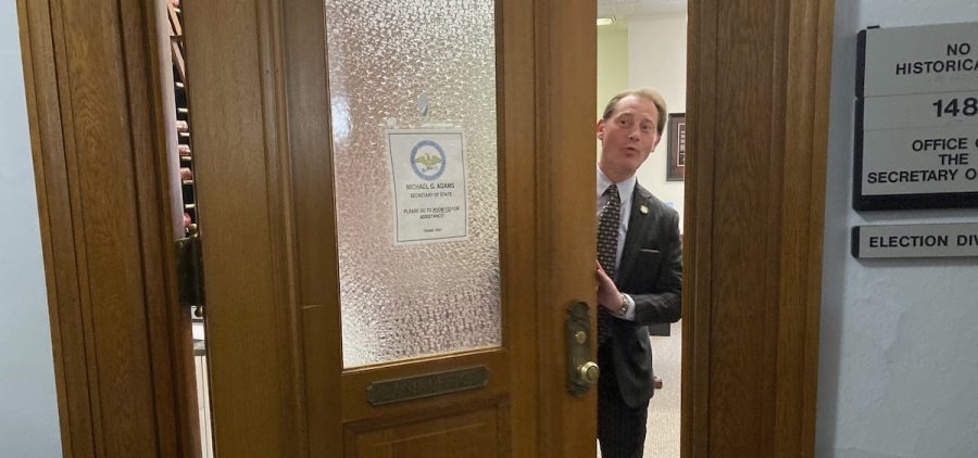 Kentucky Secretary of State Michael Adams ceremoniously closes the door to the room where candidates can file for office