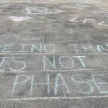 The message "being trans is not a phase" was written in chalk outside the Ohio Statehouse after a protest over a bill banning gender transition treatments for minors in May 2022.