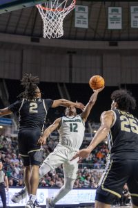 Ohio guard Jaylin Hunter (12) shoots a layup through contact against the Akron Zips. 
