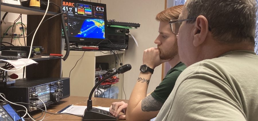 Jeff Slattery and Josh Senefeld communicate with a radio operator in Florida during the Athens County Amateur Radio Association's winter field day operation.