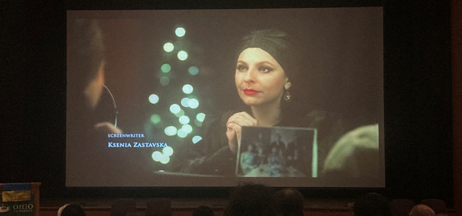 A screen in a movie theater shows the opening scene from the film "Carol of the Bells."