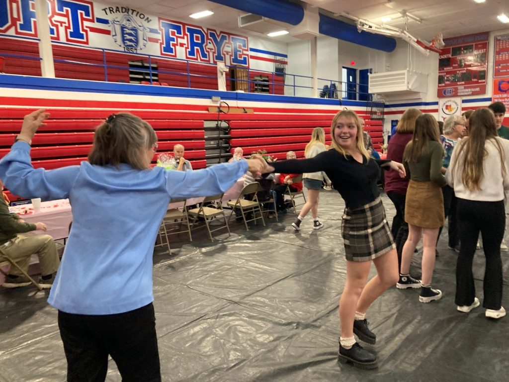 A high school student and a senior citizen dance at Fort Frye's Senior Citizen Prom.
