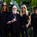 A promotional picture of the band Judas Priest. The band is outside and all of them are wearing black.