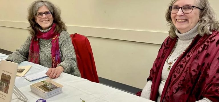 An image of authors Wendy McVicker and Cathy Cultice Lentes seated at an event for their book, "Stronger When We Touch."
